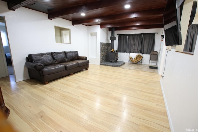 101 Hermansen, Hawthorne, NV 89415 - living room with a wood stove, beam ceiling, wooden ceiling, light wood-style flooring, and baseboards