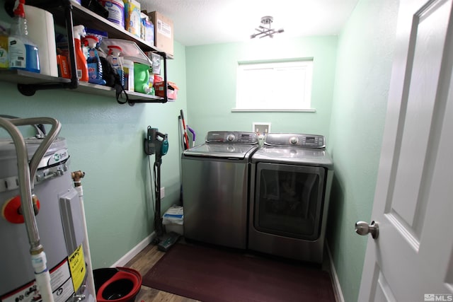 101 Hermansen, Hawthorne, NV 89415 - clothes washing area featuring washing machine and clothes dryer, electric water heater, wood finished floors, and baseboards
