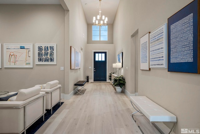 718 W Pleasant Oak Trl, Reno, NV 89511 - foyer entrance with a chandelier, a towering ceiling, wood finished floors, and baseboards