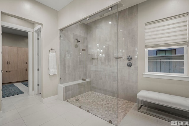 718 W Pleasant Oak Trl, Reno, NV 89511 - bathroom featuring tiled shower, baseboards, and tile patterned floors