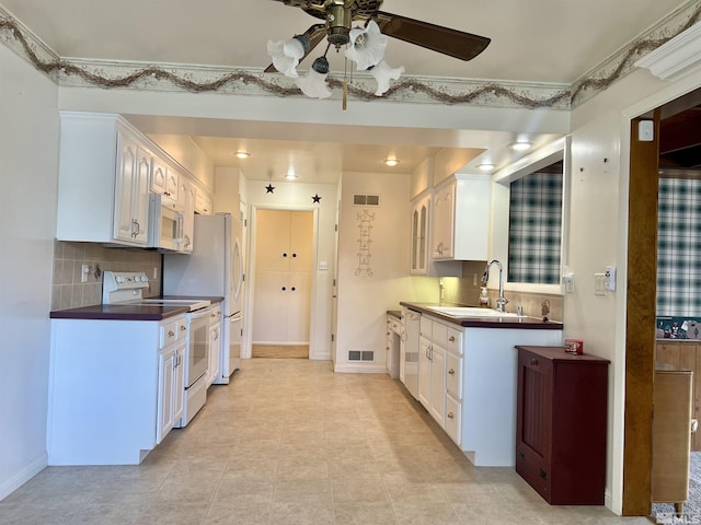 2 N Whitacre St, Yerington, NV 89447 - kitchen with white appliances, a ceiling fan, white cabinets, and a sink