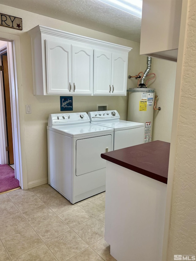 2 N Whitacre St, Yerington, NV 89447 - clothes washing area with cabinet space, water heater, washer and dryer, light tile patterned floors, and a textured wall