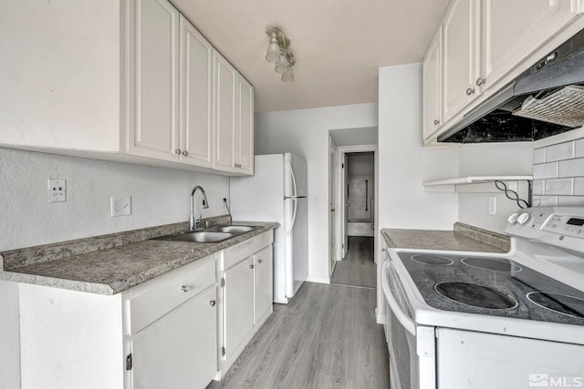 4608 Neil Rd Unit 241, Reno, NV 89502 - kitchen with white range with electric cooktop, a sink, under cabinet range hood, white cabinets, and light wood-style flooring