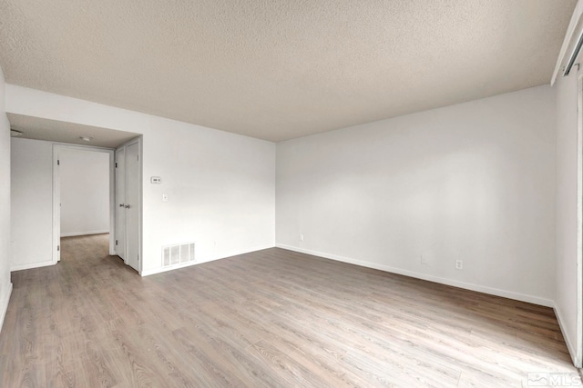 4608 Neil Rd Unit 241, Reno, NV 89502 - spare room featuring a textured ceiling, wood finished floors, and baseboards