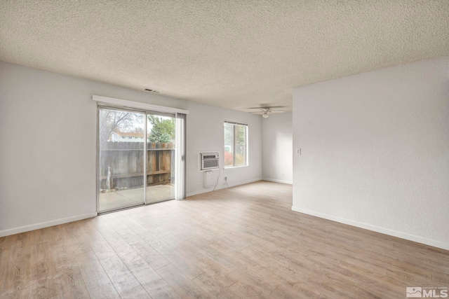 4608 Neil Rd Unit 241, Reno, NV 89502 - spare room featuring wood finished floors, baseboards, a textured ceiling, ceiling fan, and a wall unit AC