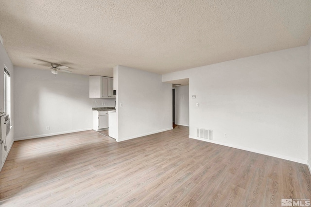 4608 Neil Rd Unit 241, Reno, NV 89502 - unfurnished living room with a textured ceiling, light wood-style flooring, a ceiling fan, and baseboards