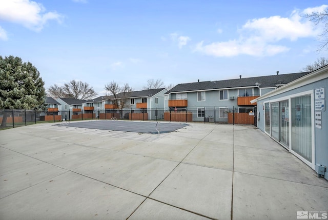 4608 Neil Rd Unit 241, Reno, NV 89502 - rear view of property featuring a residential view, fence, and a patio