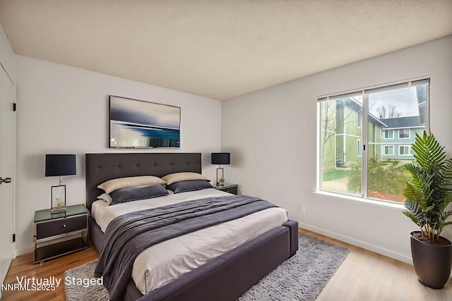 4608 Neil Rd Unit 241, Reno, NV 89502 - bedroom with multiple windows, wood finished floors, and baseboards