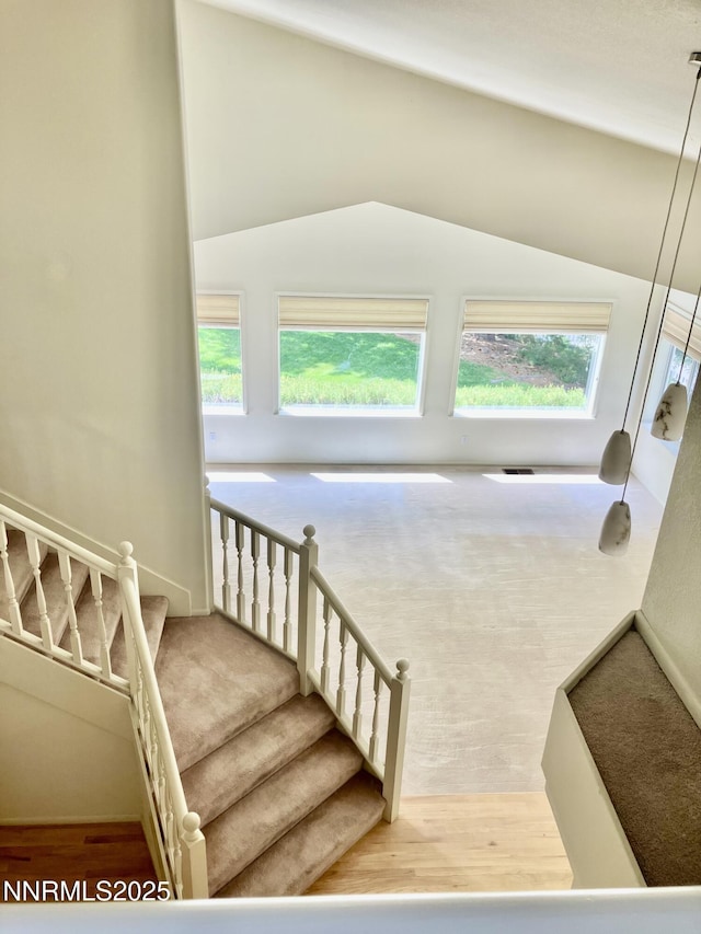 3678 Brighton Way, Reno, NV 89509 - stairway with plenty of natural light, vaulted ceiling, and carpet flooring
