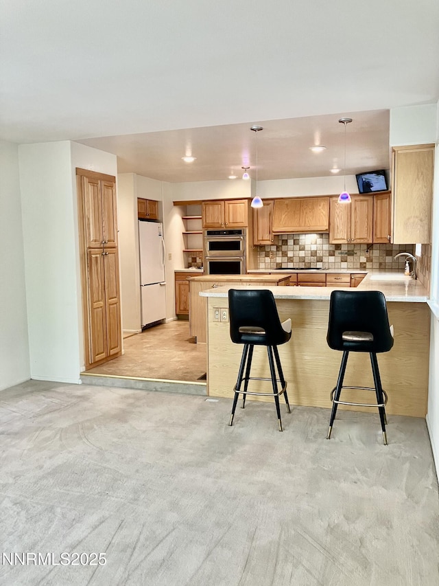 3678 Brighton Way, Reno, NV 89509 - kitchen with freestanding refrigerator, stainless steel double oven, a peninsula, light countertops, and recessed lighting