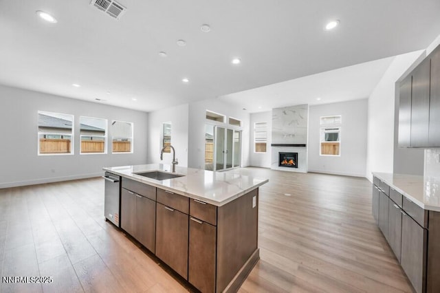 7511 Hoback Dr Unit Windsong 54, Sparks, NV 89436 - kitchen with light wood-type flooring, an island with sink, a large fireplace, healthy amount of natural light, and recessed lighting