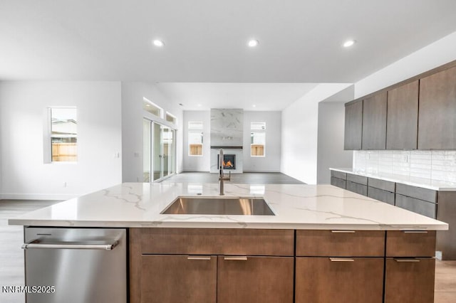7511 Hoback Dr Unit Windsong 54, Sparks, NV 89436 - kitchen featuring open floor plan, stainless steel dishwasher, recessed lighting, light stone counters, and a large fireplace