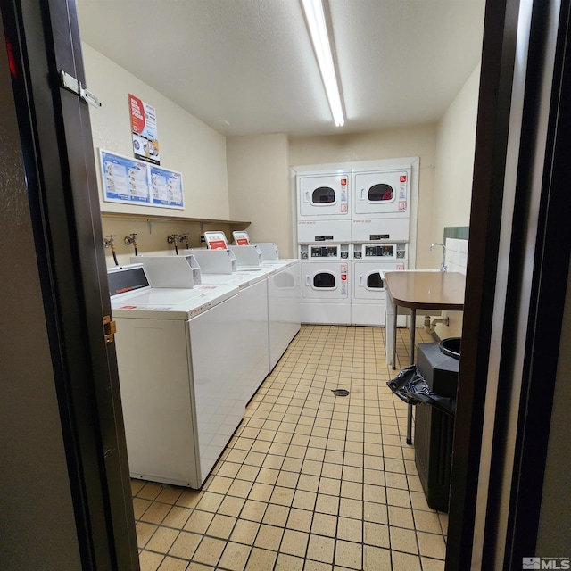 2450 Lymbery St Unit 137, Reno, NV 89509 - community laundry room with stacked washer and clothes dryer, light tile patterned floors, and washer and clothes dryer