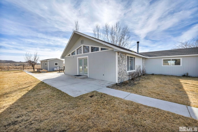 605 E US Highway 95a, Yerington, NV 89447 - view of property exterior with french doors, stone siding, and a patio