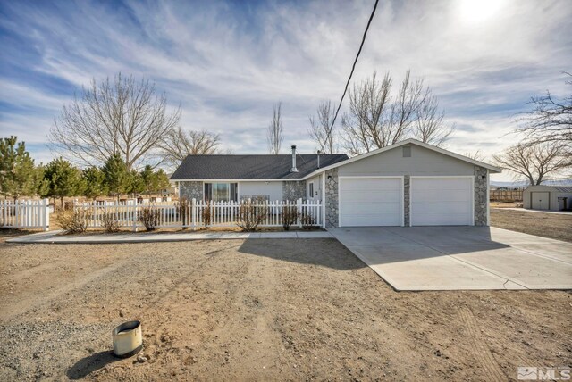 605 E US Highway 95a, Yerington, NV 89447 - single story home with a garage, driveway, stone siding, and a fenced front yard