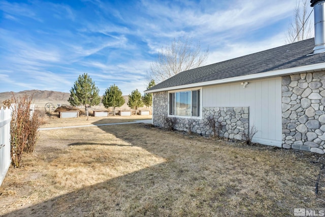 605 E US Highway 95a, Yerington, NV 89447 - view of property exterior featuring stone siding, a shingled roof, and a mountain view