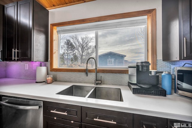 605 E US Highway 95a, Yerington, NV 89447 - kitchen featuring stainless steel appliances, a sink, backsplash, light countertops, and dark cabinets