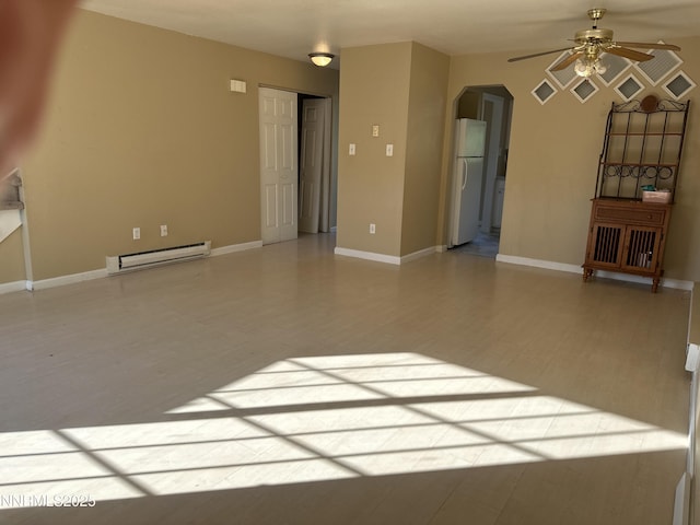 474 Smithridge Pkwy, Reno, NV 89502 - unfurnished living room with a baseboard heating unit, a ceiling fan, arched walkways, baseboards, and wood finished floors