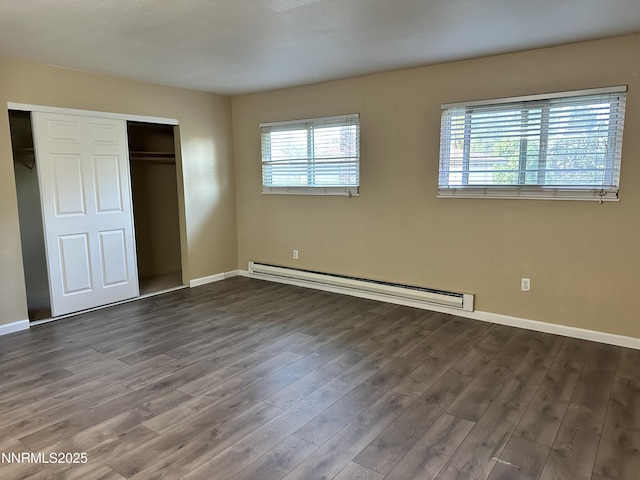 474 Smithridge Pkwy, Reno, NV 89502 - unfurnished bedroom featuring a baseboard heating unit, dark wood-type flooring, baseboards, and a closet
