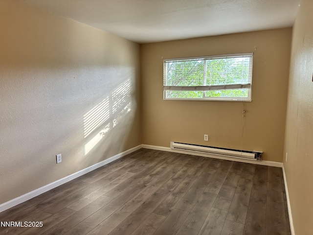 474 Smithridge Pkwy, Reno, NV 89502 - spare room featuring a baseboard radiator, dark wood-type flooring, and baseboards