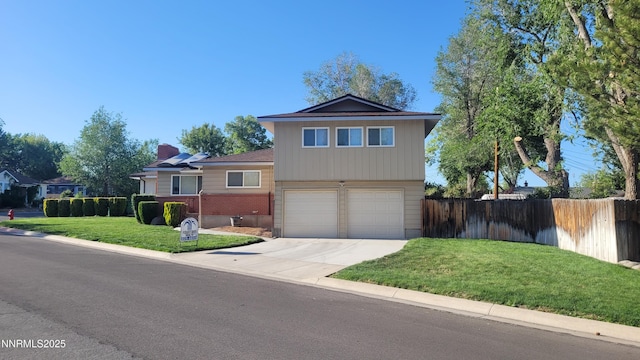 421 Glenmanor Dr, Reno, NV 89509 - split level home with brick siding, an attached garage, a chimney, and driveway