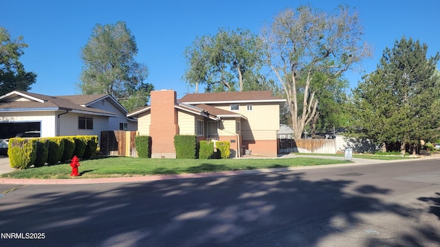 421 Glenmanor Dr, Reno, NV 89509 - view of front of home with a chimney, brick siding, and a garage