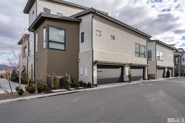 62 Caballada St, Reno, NV 89511 - view of property exterior with an attached garage and driveway