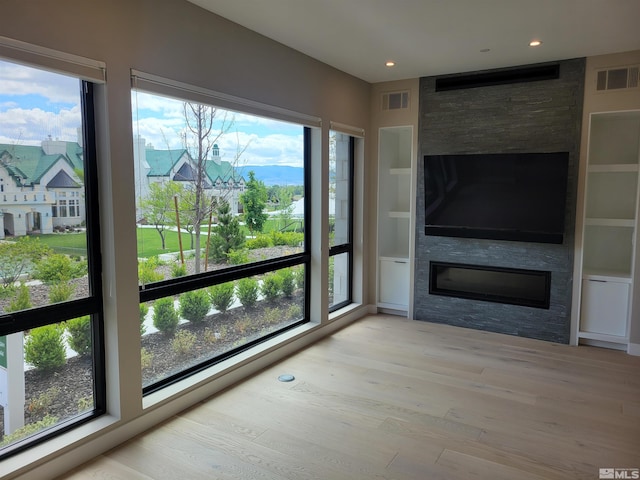 62 Caballada St, Reno, NV 89511 - unfurnished living room with a fireplace, wood finished floors, recessed lighting, and built in features