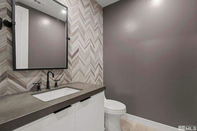 62 Caballada St, Reno, NV 89511 - half bathroom with toilet, vanity, backsplash, and baseboards