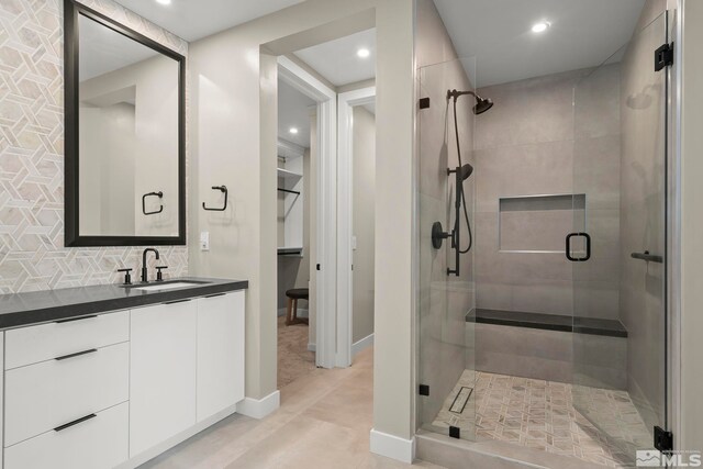 62 Caballada St, Reno, NV 89511 - full bathroom featuring a shower stall, recessed lighting, vanity, decorative backsplash, and baseboards
