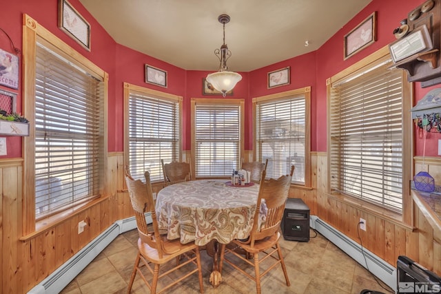 5650 S Allen Rd, Fallon, NV 89406 - dining space with wooden walls, baseboard heating, a wainscoted wall, and light tile patterned floors