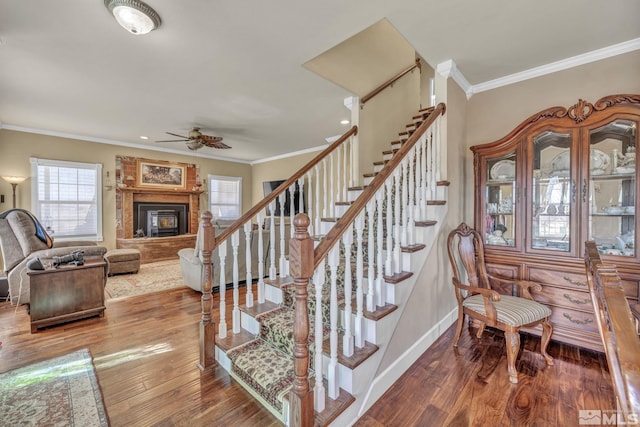 5650 S Allen Rd, Fallon, NV 89406 - stairway featuring ceiling fan, ornamental molding, wood finished floors, a glass covered fireplace, and baseboards
