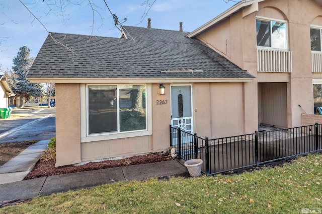 2267 Rock Blvd, Sparks, NV 89431 - view of front of property featuring roof with shingles, fence, and stucco siding