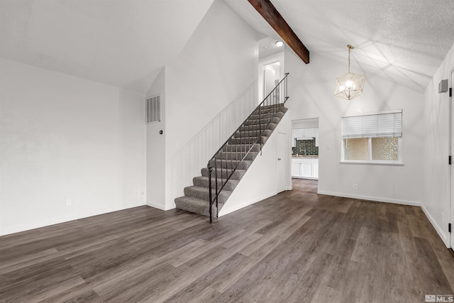 2267 Rock Blvd, Sparks, NV 89431 - unfurnished living room with stairs, a chandelier, high vaulted ceiling, dark wood-style floors, and beamed ceiling
