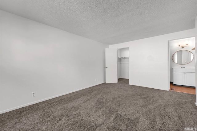 2267 Rock Blvd, Sparks, NV 89431 - unfurnished bedroom featuring carpet, a textured ceiling, a closet, connected bathroom, and baseboards