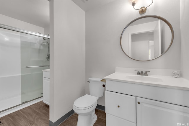 2267 Rock Blvd, Sparks, NV 89431 - bathroom with wood finished floors, a stall shower, vanity, toilet, and baseboards