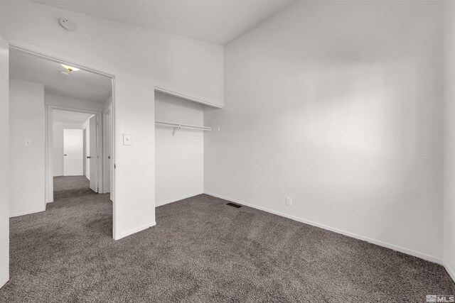 2267 Rock Blvd, Sparks, NV 89431 - unfurnished bedroom with dark colored carpet, baseboards, and a closet