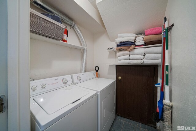 758 Milky Way Ct, Stateline, NV 89449 - laundry area featuring washing machine and dryer, dark tile patterned flooring, and a textured wall