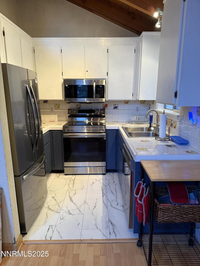 758 Milky Way Ct, Stateline, NV 89449 - kitchen with stainless steel appliances, a sink, decorative backsplash, tile countertops, and light marble finish flooring