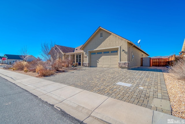 11725 Paradise View Dr, Sparks, NV 89441 - ranch-style house with a garage, stucco siding, driveway, and a gate