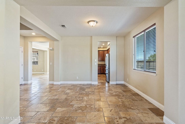 8389 Opal Ranch Way, Reno, NV 89506 - spare room featuring stone tile floors, plenty of natural light, baseboards, and recessed lighting