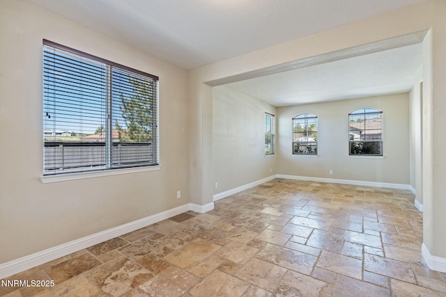 8389 Opal Ranch Way, Reno, NV 89506 - unfurnished room featuring stone tile floors and baseboards