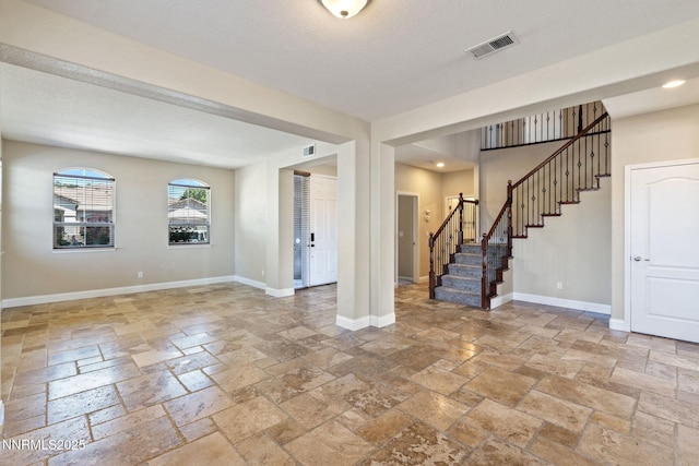 8389 Opal Ranch Way, Reno, NV 89506 - unfurnished living room with stone tile flooring, stairway, baseboards, and recessed lighting