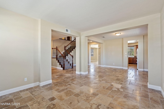 8389 Opal Ranch Way, Reno, NV 89506 - empty room featuring stone tile flooring, stairs, and baseboards