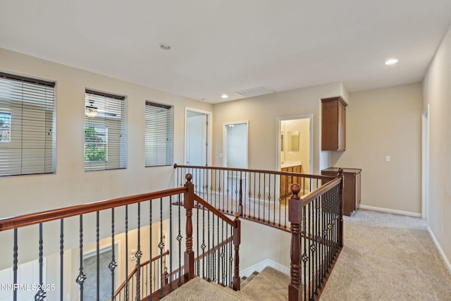 8389 Opal Ranch Way, Reno, NV 89506 - hallway with an upstairs landing, light colored carpet, recessed lighting, and baseboards