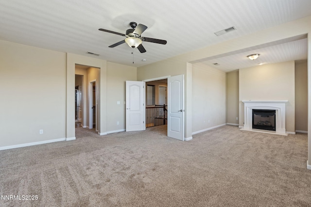 8389 Opal Ranch Way, Reno, NV 89506 - unfurnished living room featuring carpet floors, ceiling fan, a glass covered fireplace, and baseboards