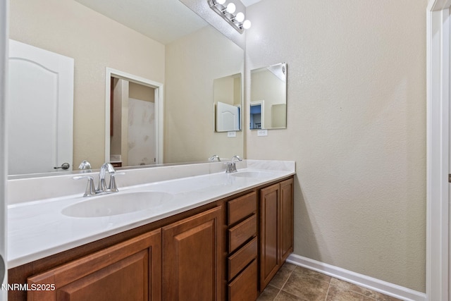 8389 Opal Ranch Way, Reno, NV 89506 - bathroom featuring double vanity, tile patterned flooring, and baseboards