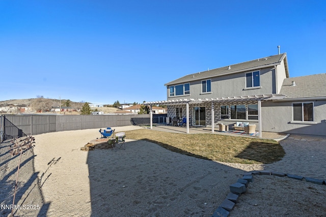 8389 Opal Ranch Way, Reno, NV 89506 - rear view of house with a pergola, a fenced backyard, a patio, stucco siding, and outdoor lounge area
