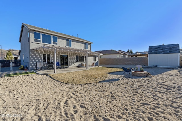 8389 Opal Ranch Way, Reno, NV 89506 - back of property with an outdoor fire pit, a pergola, a fenced backyard, and a patio