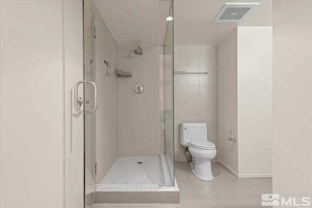 255 N Sierra St Unit 606, Reno, NV 89501 - bathroom with toilet, tile patterned floors, a shower stall, and baseboards